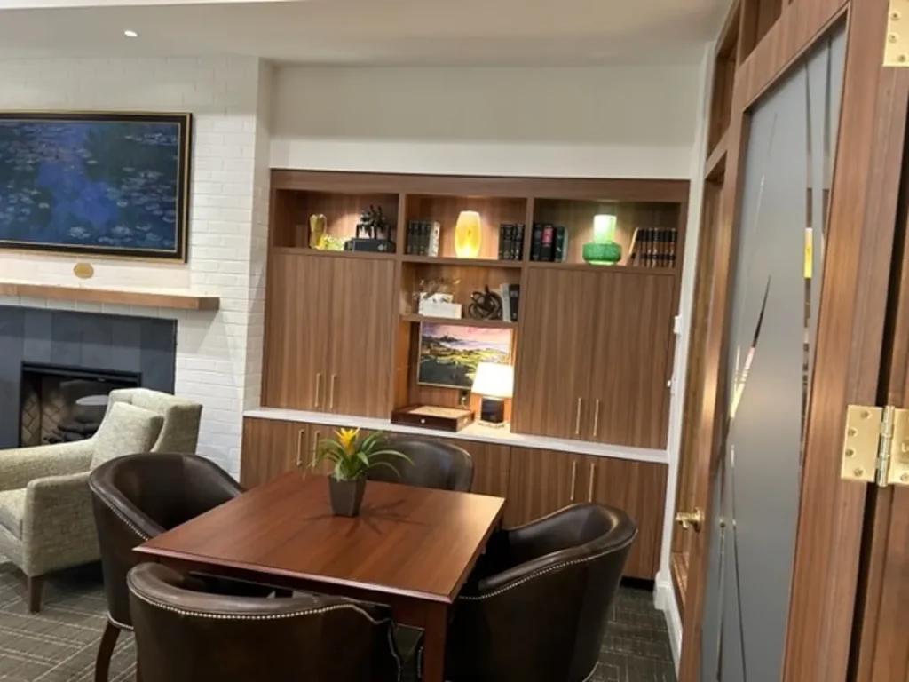 cozy seating area with fireplace and bookshelves st james square superior millworks