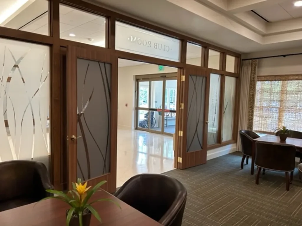 entrance to club room with wooden doors and frosted glass st james square superior millworks